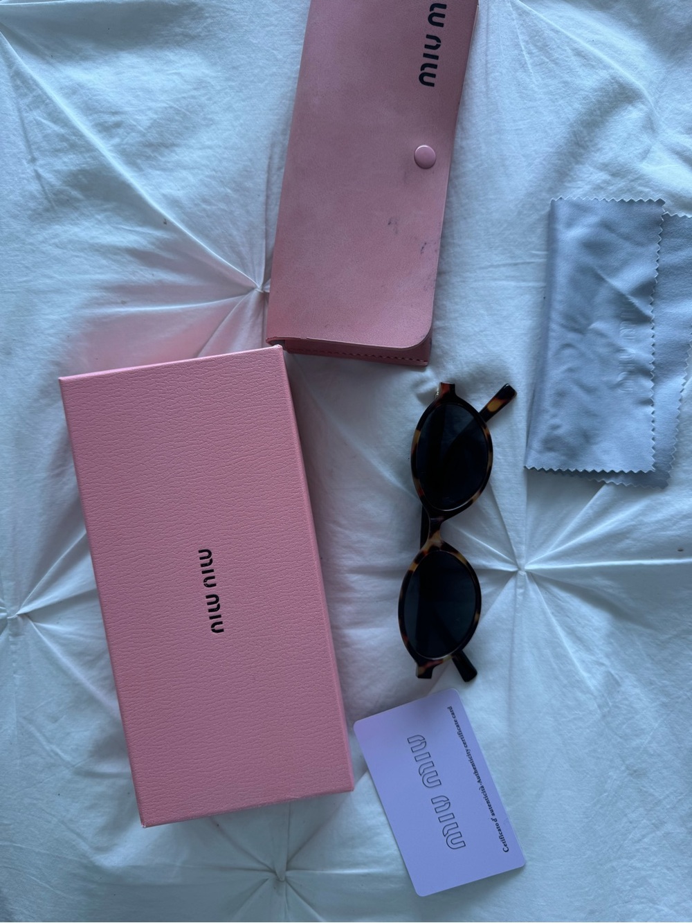 Miu Miu Tortoiseshell Oval Sunglasses with Pink Accessories